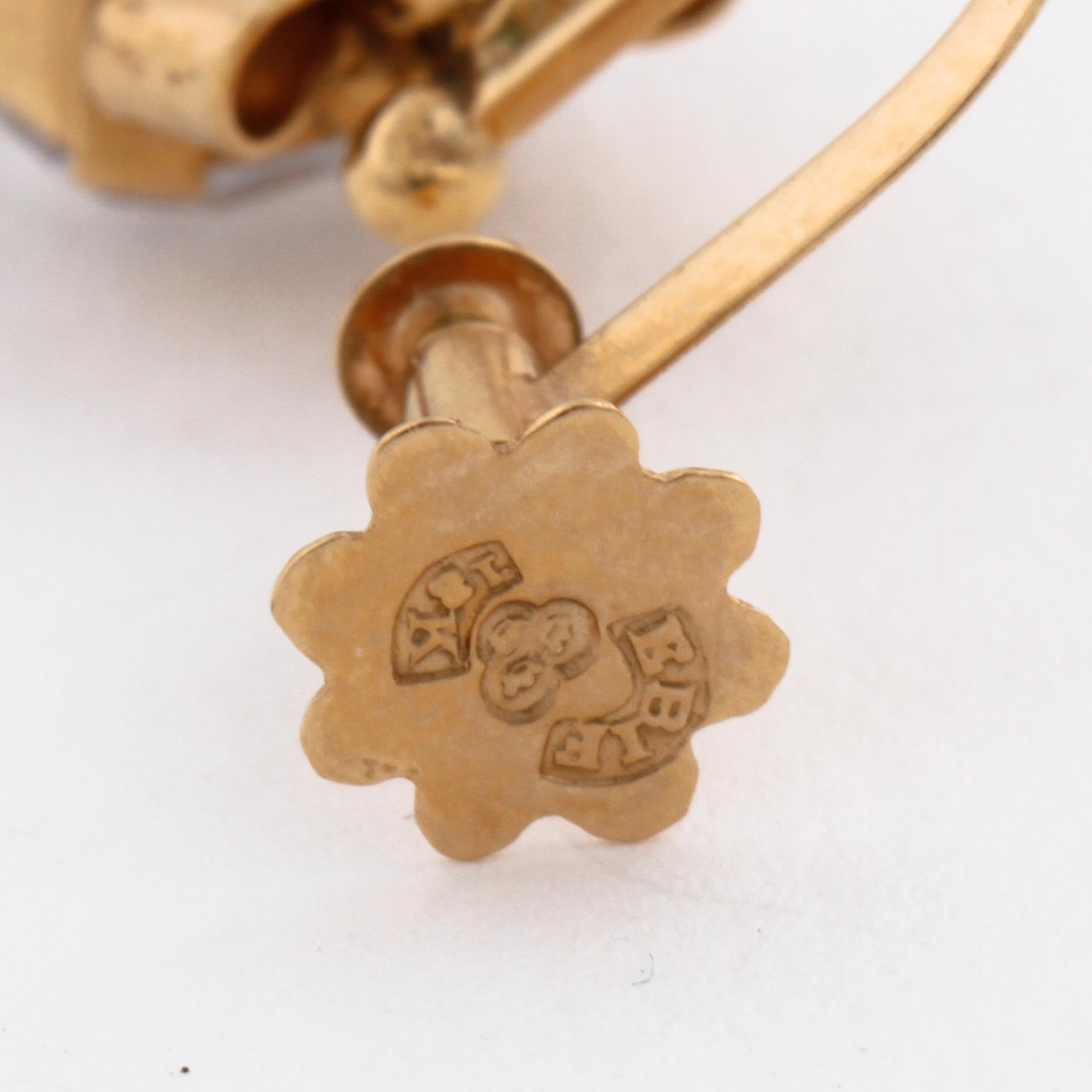 A citrine pendant and a pair of synthetic spinell earrings.