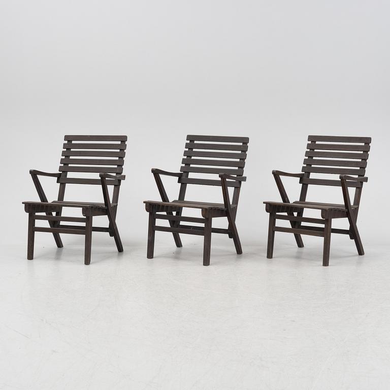 Carl Malmsten, a set three stained pine armchairs, Igelstaverken, second half of the 20th Century.