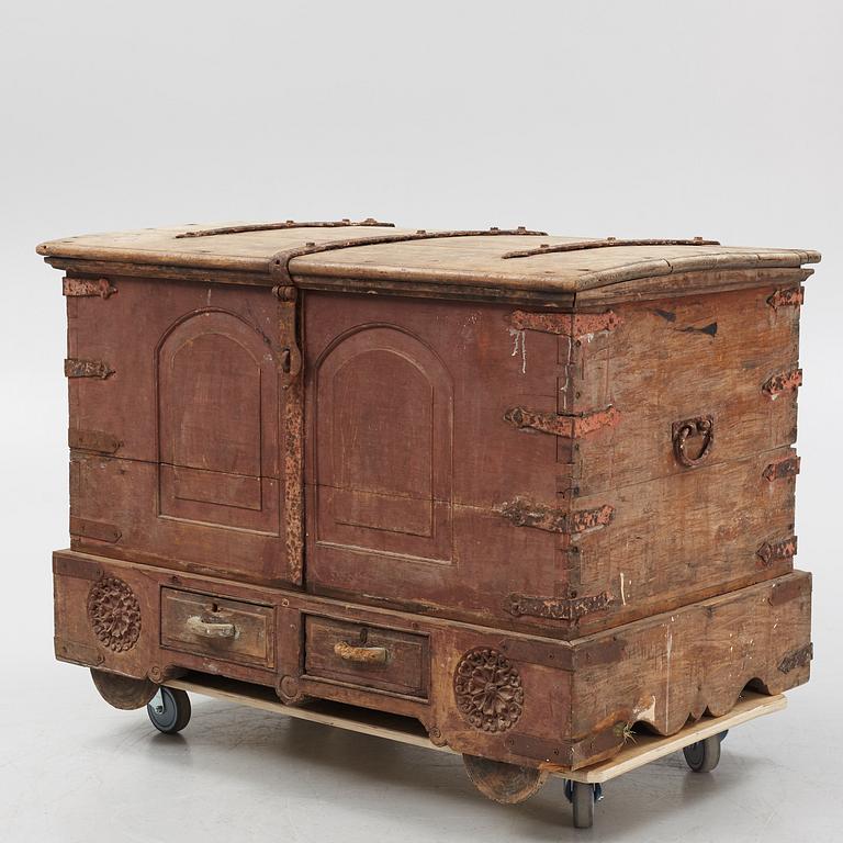 A carved oak chest with wrought iron fittings, 19th Century.