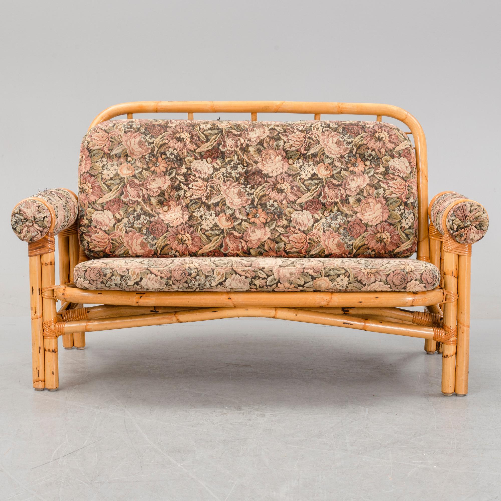 A set of two garden sofas, an armchair and a glass table, later part of the 20th Century.