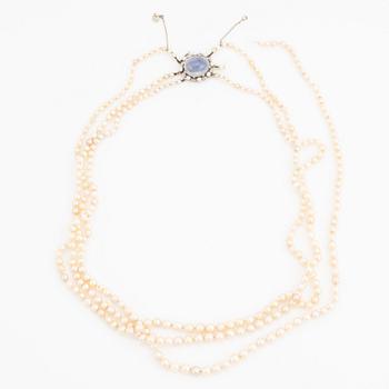 Three strand pearl necklace, clasp with cabochon cut sapphire.