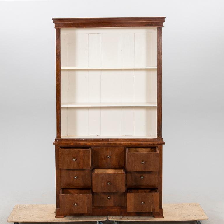 A stained walnut cabinet from the first half of the 20th century.