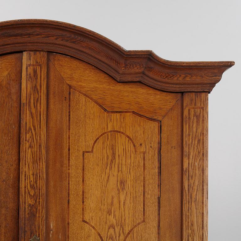 An oak rococo cabinet, mid 18th Century.