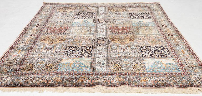 An oriental silk carpet, c. 305 x 205 cm.