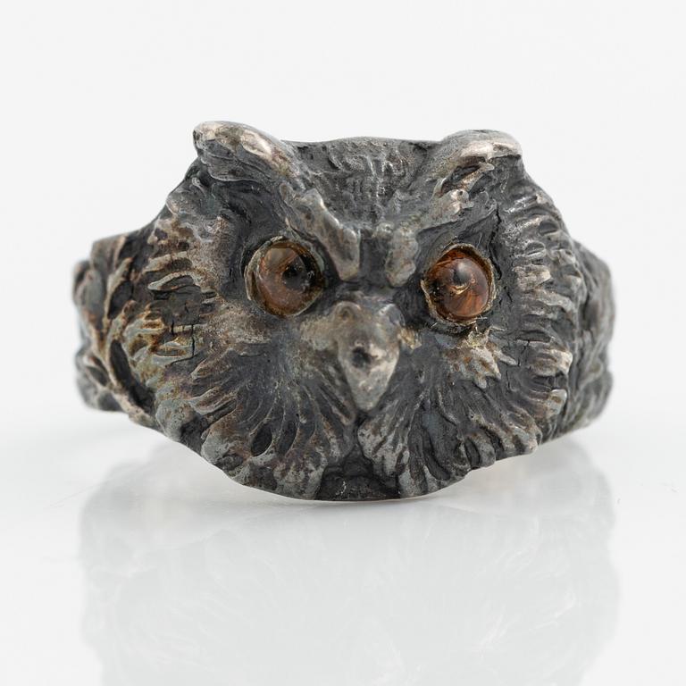Ring in the form of an owl, silver with orange stone.