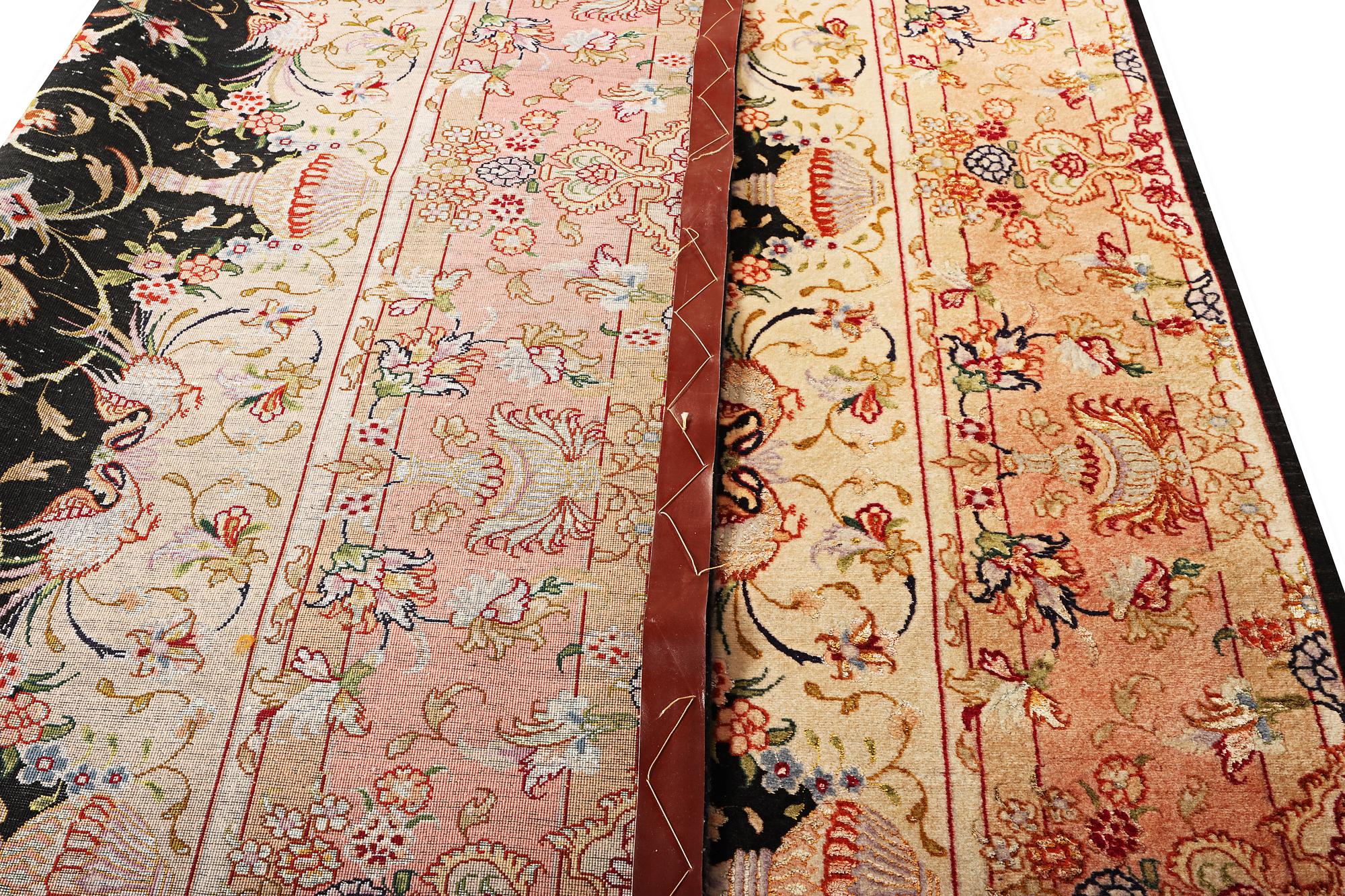 A Tabriz rug, part silk, 50 raj, a. 210 x 147 cm.