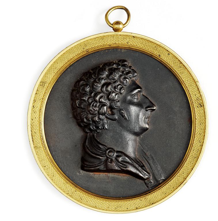 A Swedish Empire iron cast ant gilt bronze portrait medallion representing Karl XIV Johan as Crown Prince.