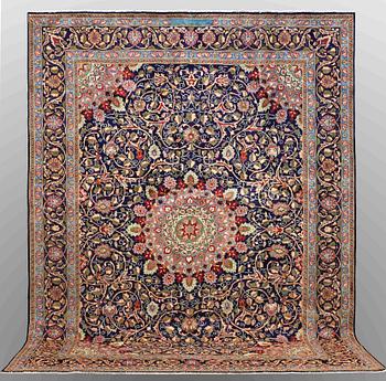 A carpet, Kashmar, signed, ca 390 x 295 cm.