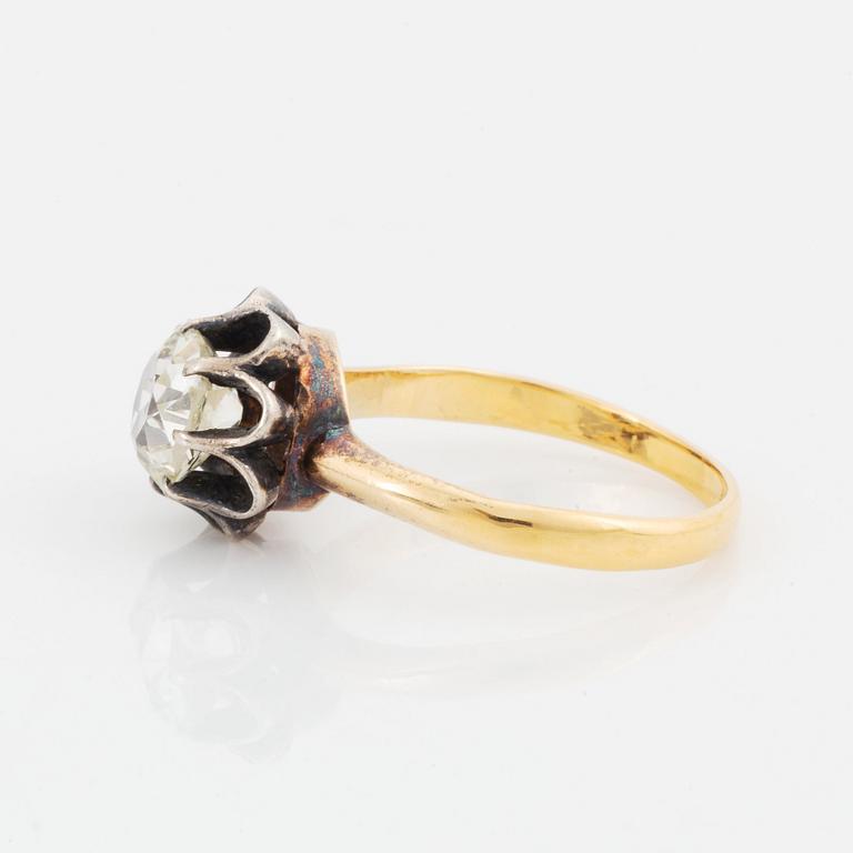 An 18K gold and silver ring set with an old-cut diamond.