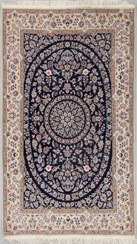 A part silk rug from Nain, around 218 x 126 cm.