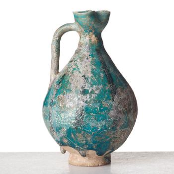 A EWER, pottery, Persia 13th century, probably 
Kashan, height ca 17,5 cm.