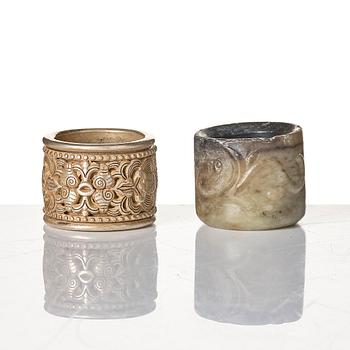 Two archers rings and two nephrite carvings.