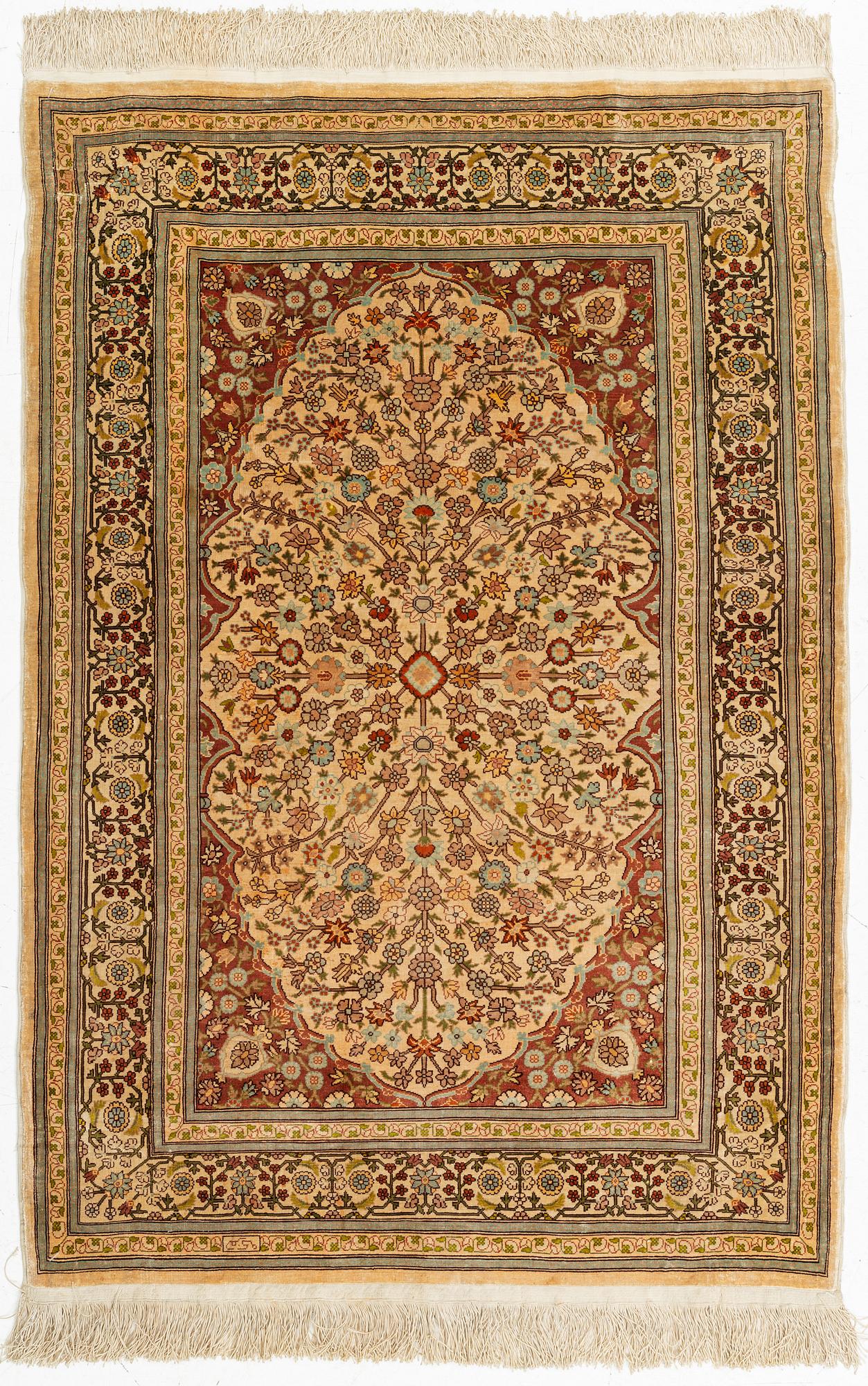 A silk Hereke rug, circa 104 x 70 cm.