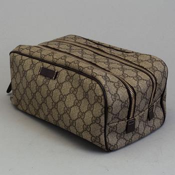 GUCCI, a monogram beauty bag.