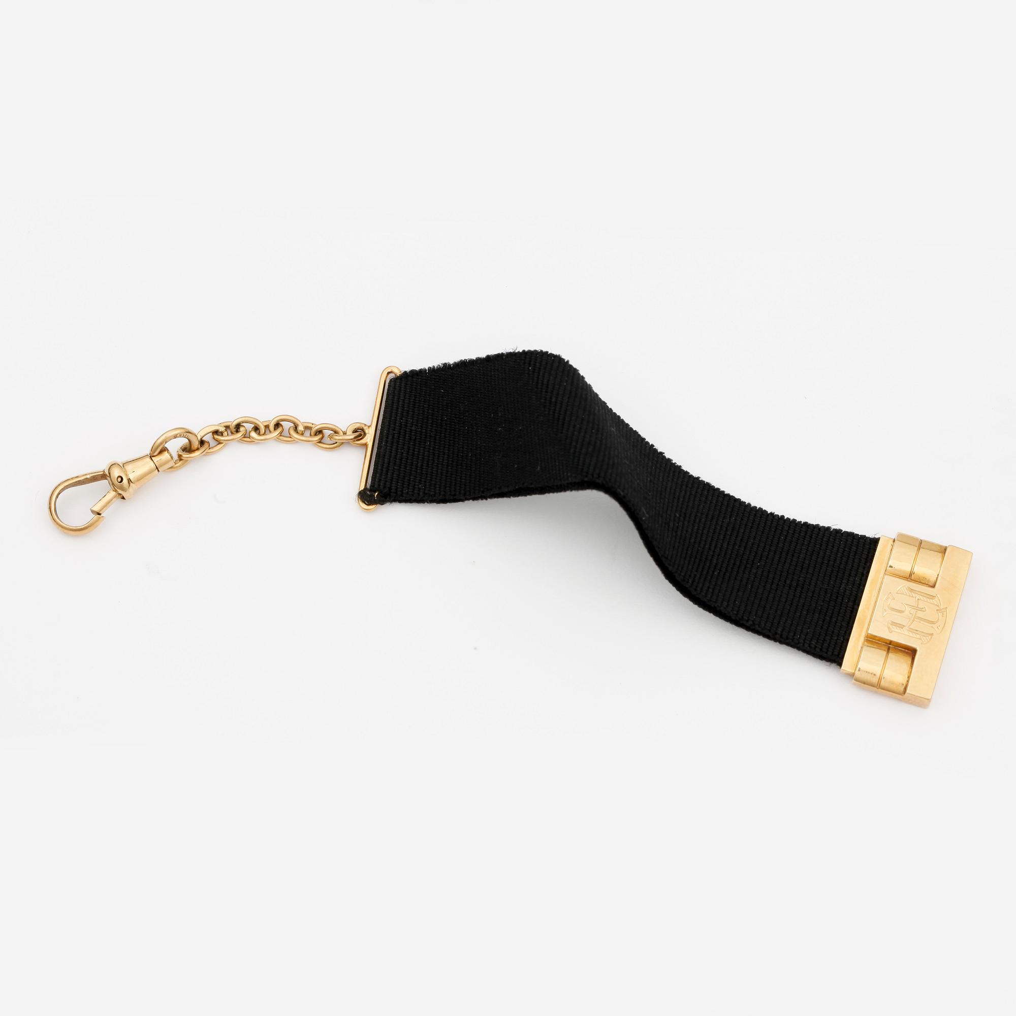 CHATELAINE, svart ripsband, guld 18k, 1930-tal. Tot ca 6 gram.