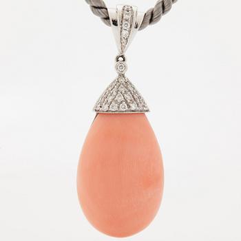 An 18K white gold and coral pendant set with round brilliant-cut diamonds.