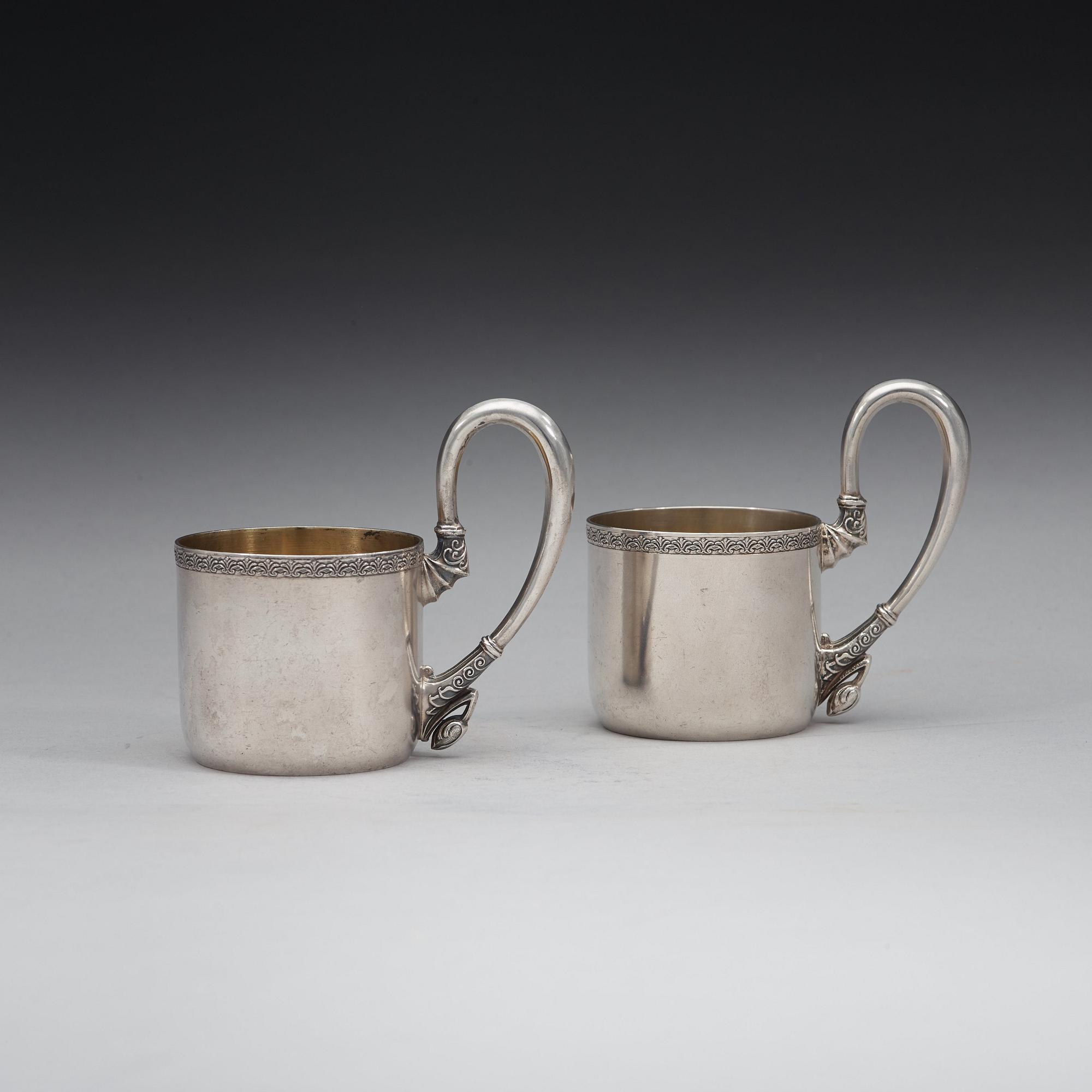 A pair of Russian 20th century parcel-gilt tea-glas holders, marks possibly of Vasily Andreyev, Moscow 1908-1917.