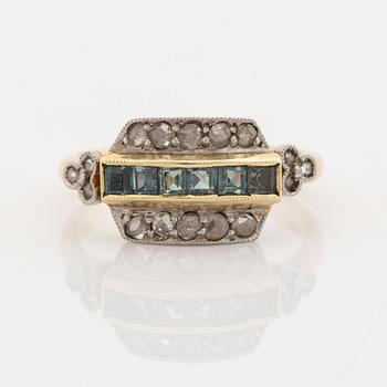 A 14K gold and platinum ring set with green stones and rose-cut diamonds.