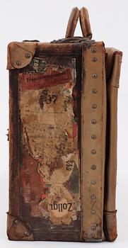 A late 19th cent leather suitcase by Louis Vuitton.