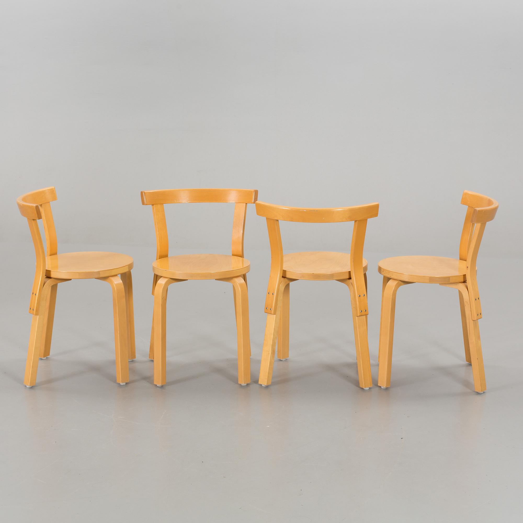A TABLE AND FOUR CHAIRS DESIGNED BY ALVAR AALTO FOR ARTEK.