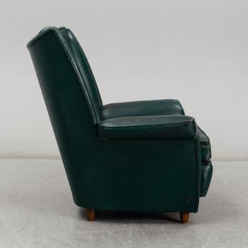 A Collins & Hayes armchair, mid 20th century. Signed with label.