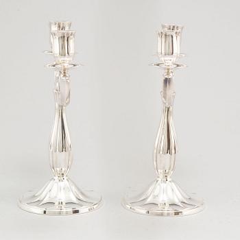 A pair of Swedish silver candelabra, makers mark GAB, Stockholm 1935 and 1938.