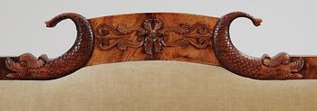 A mahogny veneer Empire sofa. 19th Century.