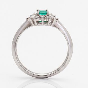 A platinum ring, with an emerald and brilliant- and marquise-cut diamonds.