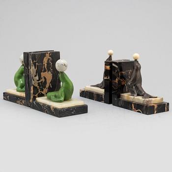 Two pairs of 20th century Art Deco bookstands decorated with sealions.