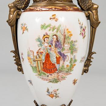 A pair of urns with lids, in bronze and porcelain, 20th century.