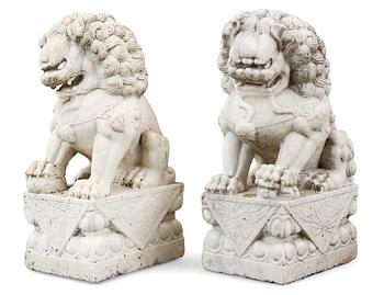 1705. A pair of marble figures of 'Buddhist Lions', China.