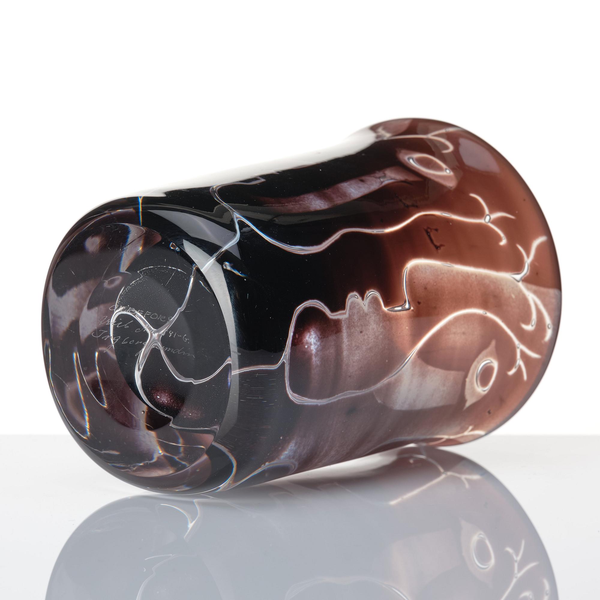 Ingeborg Lundin, an 'ariel' burgundy coloured glass vase decorated with faces, Orrefors Sweden 1972.