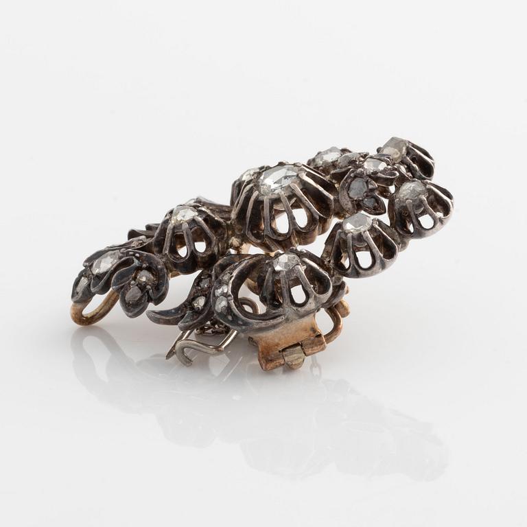 A silver brooch set with rose-cut diamonds.