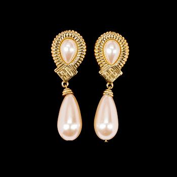 1500. A pair of golden earclips by Givenchy.
