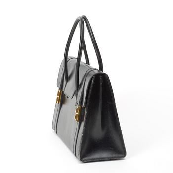 A 1950s black leather handbag by Hermès.