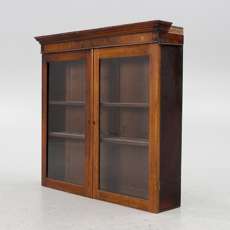 A mahogany veneered vitrine wal cabinet.