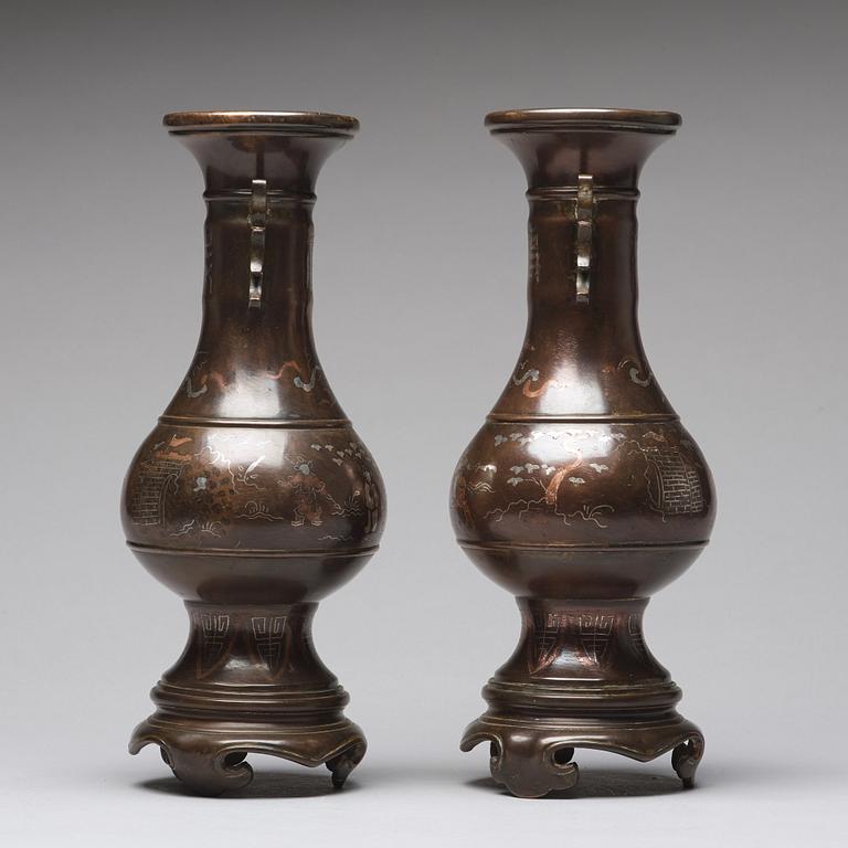 A pair of bronze vases with copper and silver inlay, Qing dynasty (1664-1912).