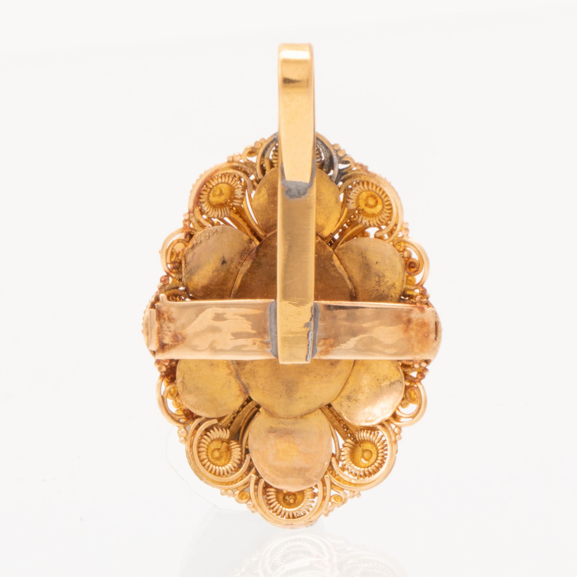 Hänge 22K guld med cabochonslipad svart stjärnsafir och rubiner.