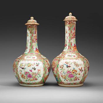 A pair of famille rose Canton vases with covers, Qing dynasty, 19th Century.