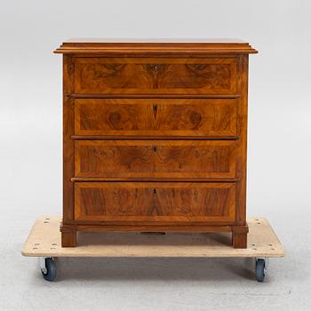 A walnut-veneered dresser, around 1900.