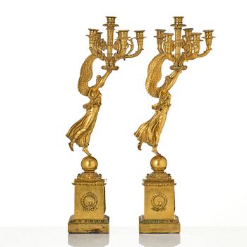 A pair of six-branch gilt bronze Empire candelabra, Paris, early 19th century.