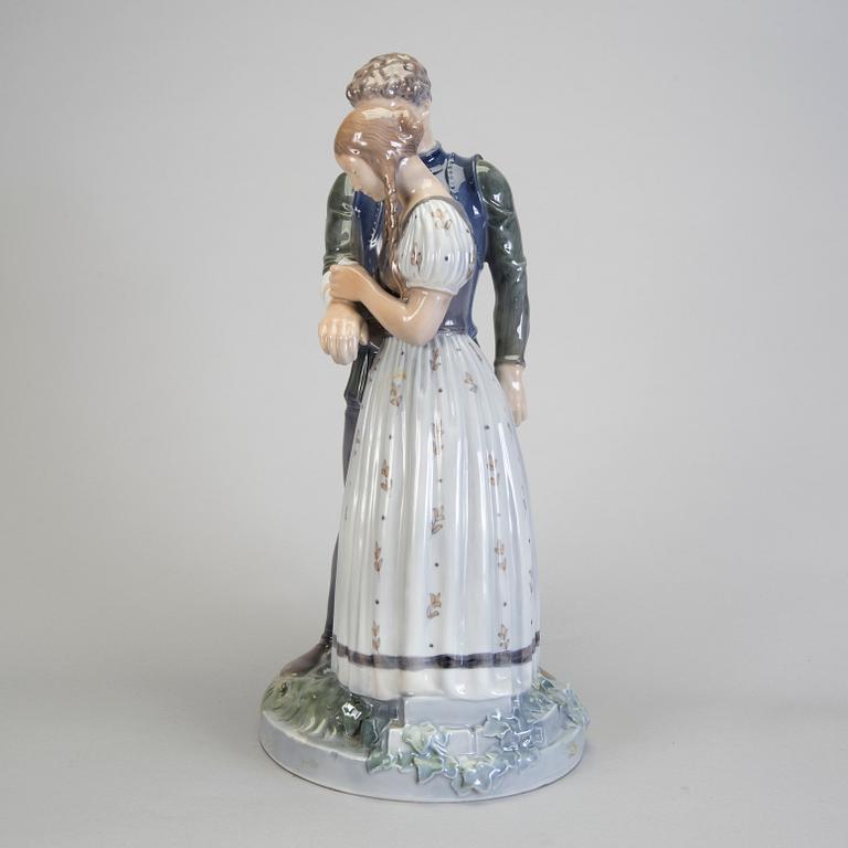 A porcelain figurine of a boy and girl model 3171 Royal Copenhagen.