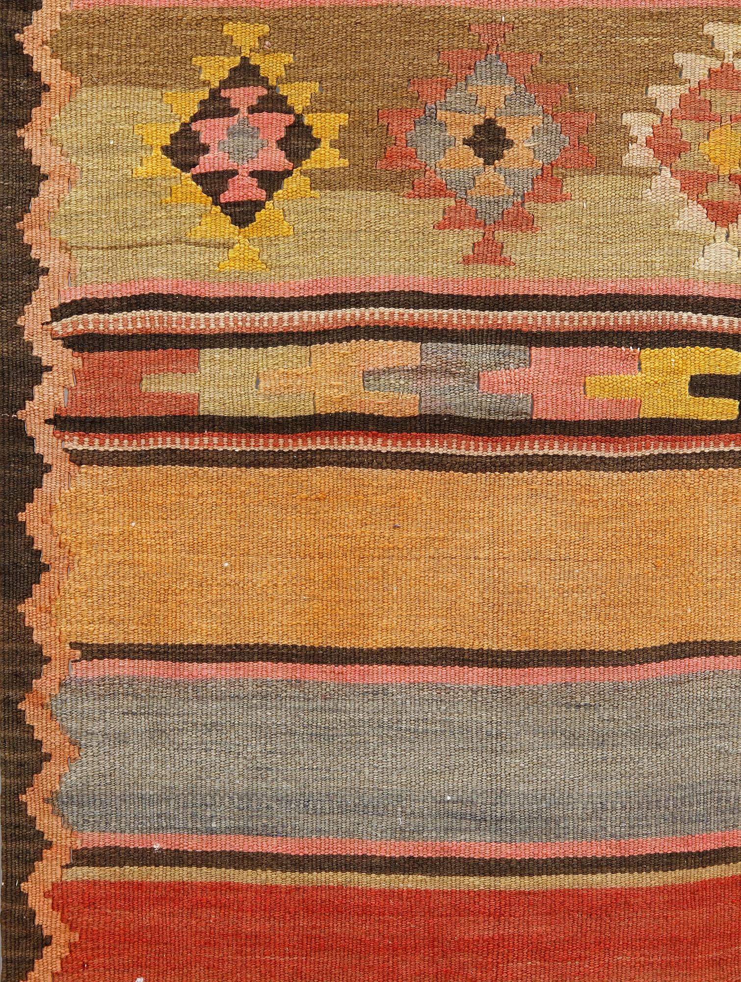 A semi-antique Nomadic Kilim rug, approx. 383 x 153 cm.