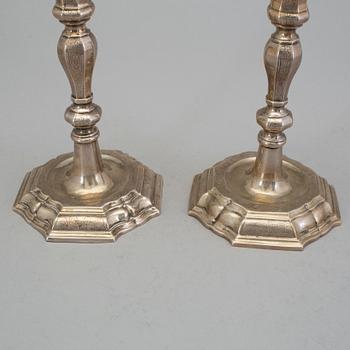 A pair of 18h century silver candlesticks, unidentified marks.