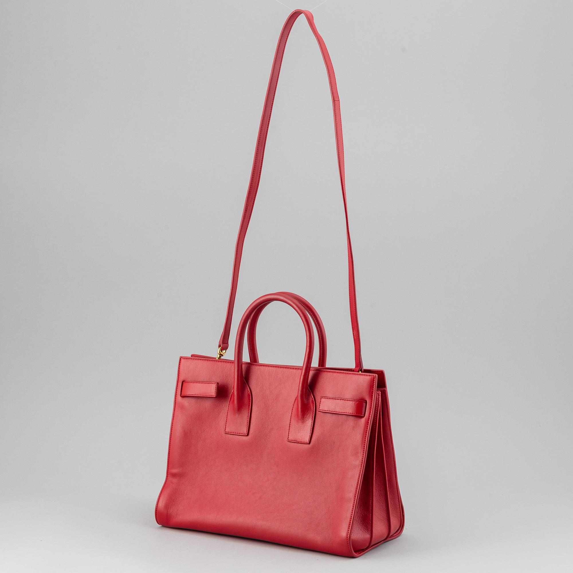 Saint Laurent, a red leather 'Sac du Jour Small' bag.