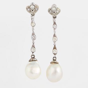 Diamond and pearl long white gold earrings.