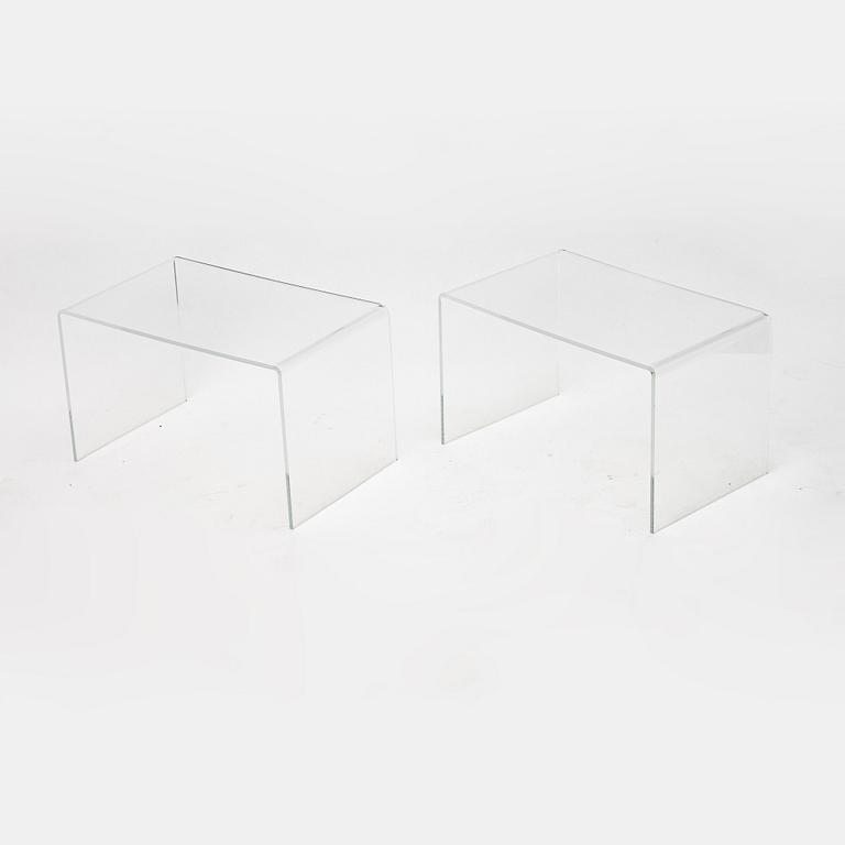 A contemporary pair of plastic tables.