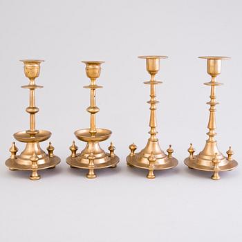 Four Russian brass candlesticks, two marked Pimenov, around 1900.