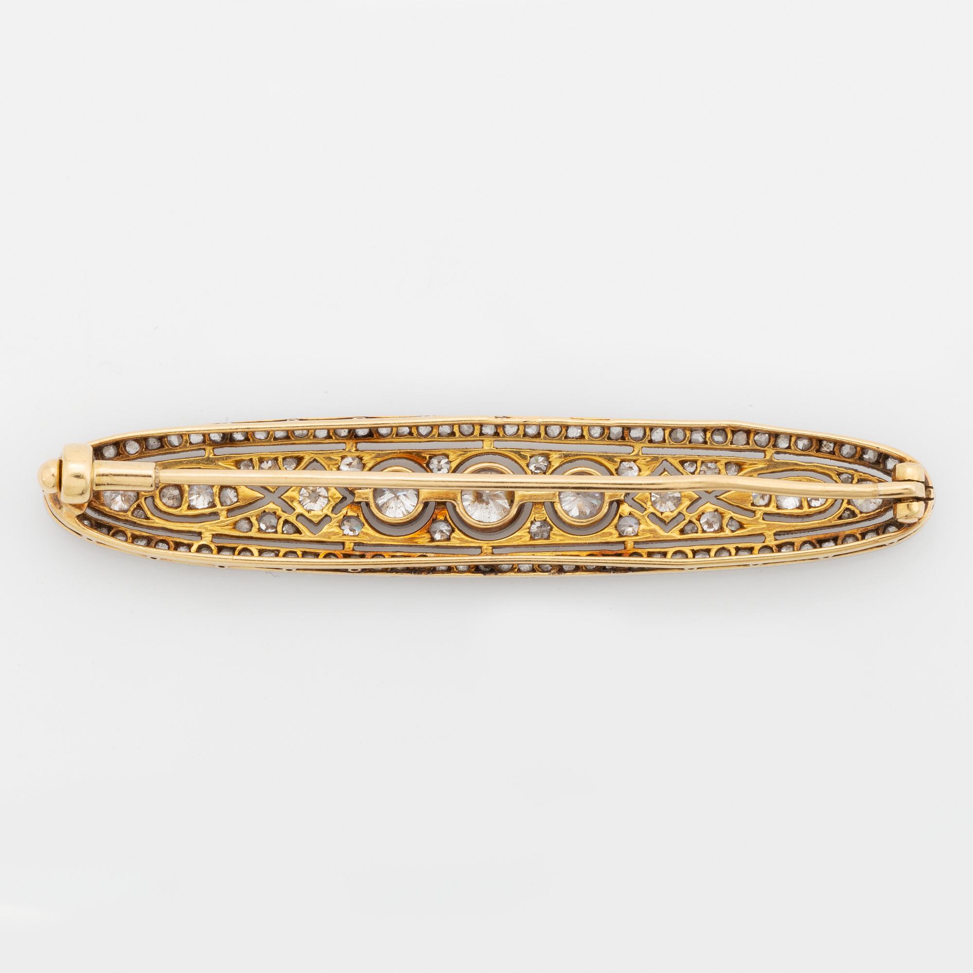 A platinum and 18K gold brooch set with old- and rose-cut diamonds.
