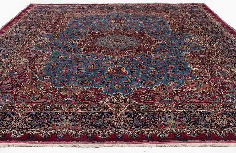 A Mashad carpet, signed Saber, c. 468 x 348 cm.
